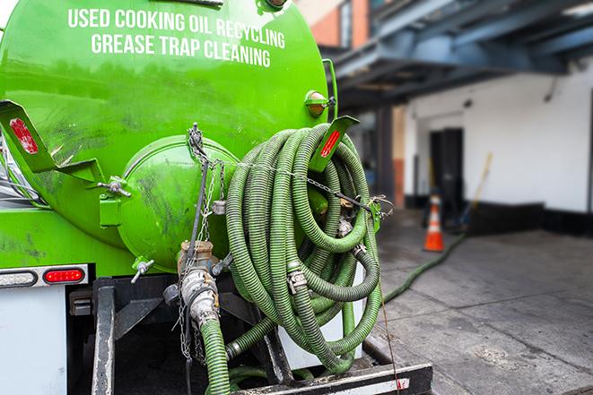 a grease trap being pumped by a sanitation technician in Antelope